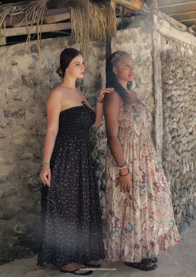 Two models in a black strapless dress and a floral maxi dress, Bali Garment Tailor resortwear catalog 2026