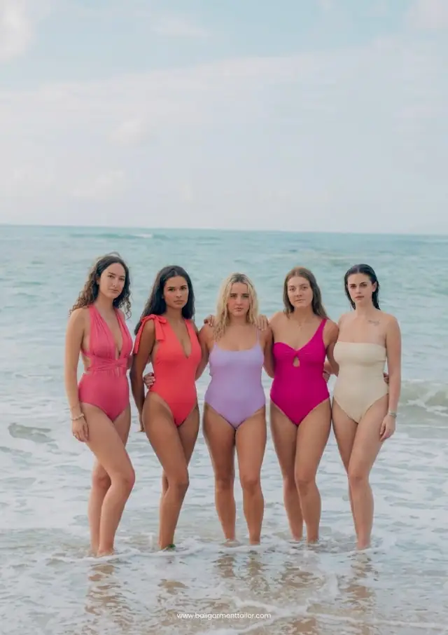 Five models in one piece swimsuits in the sea, Bali Garment Tailor swim catalog 2026